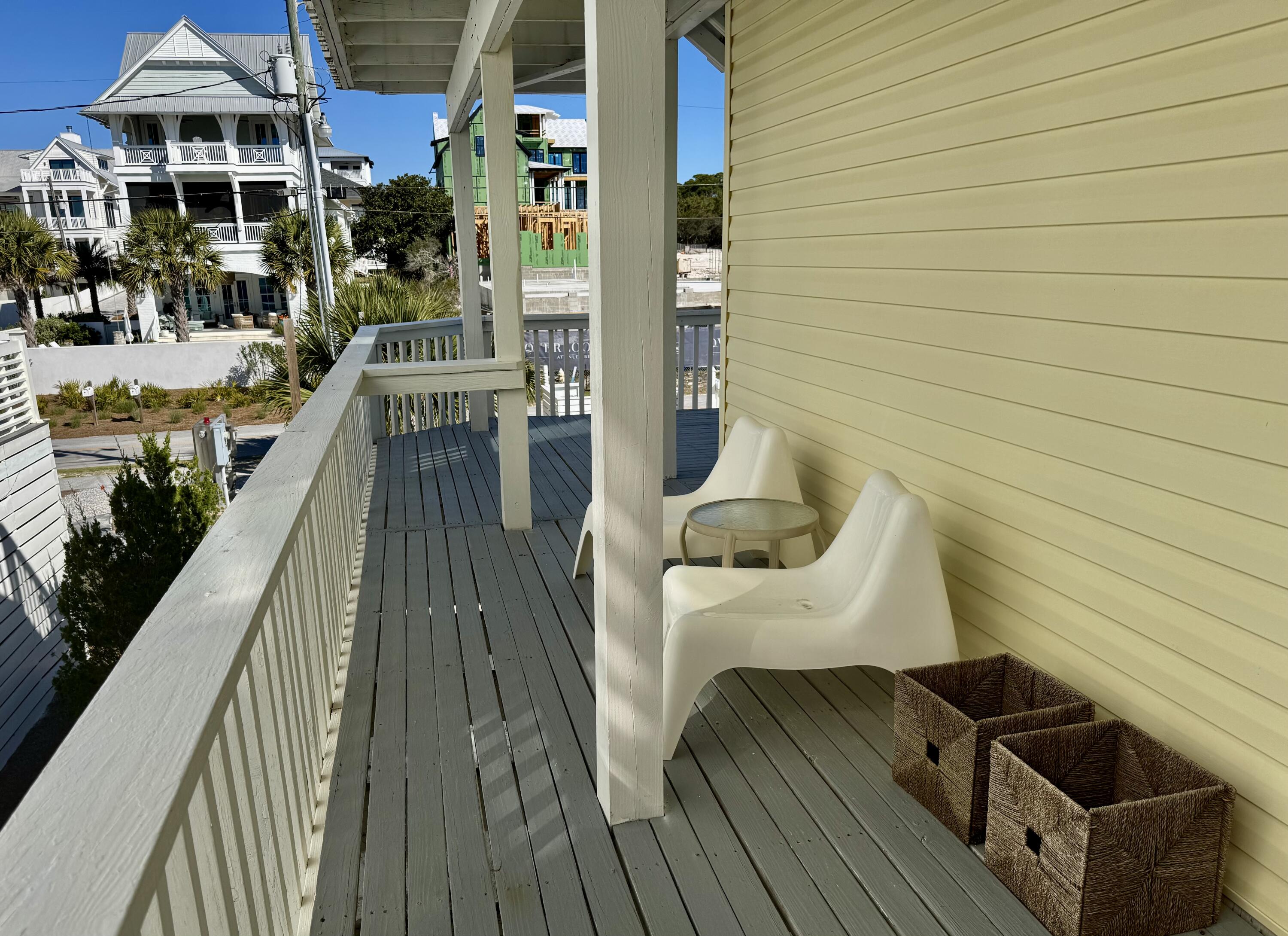 228 Walton Magnolia Lane, Unit 9 Inlet Beach, FL 32461 - Photo 11 of 24 a balcony with table and chairs