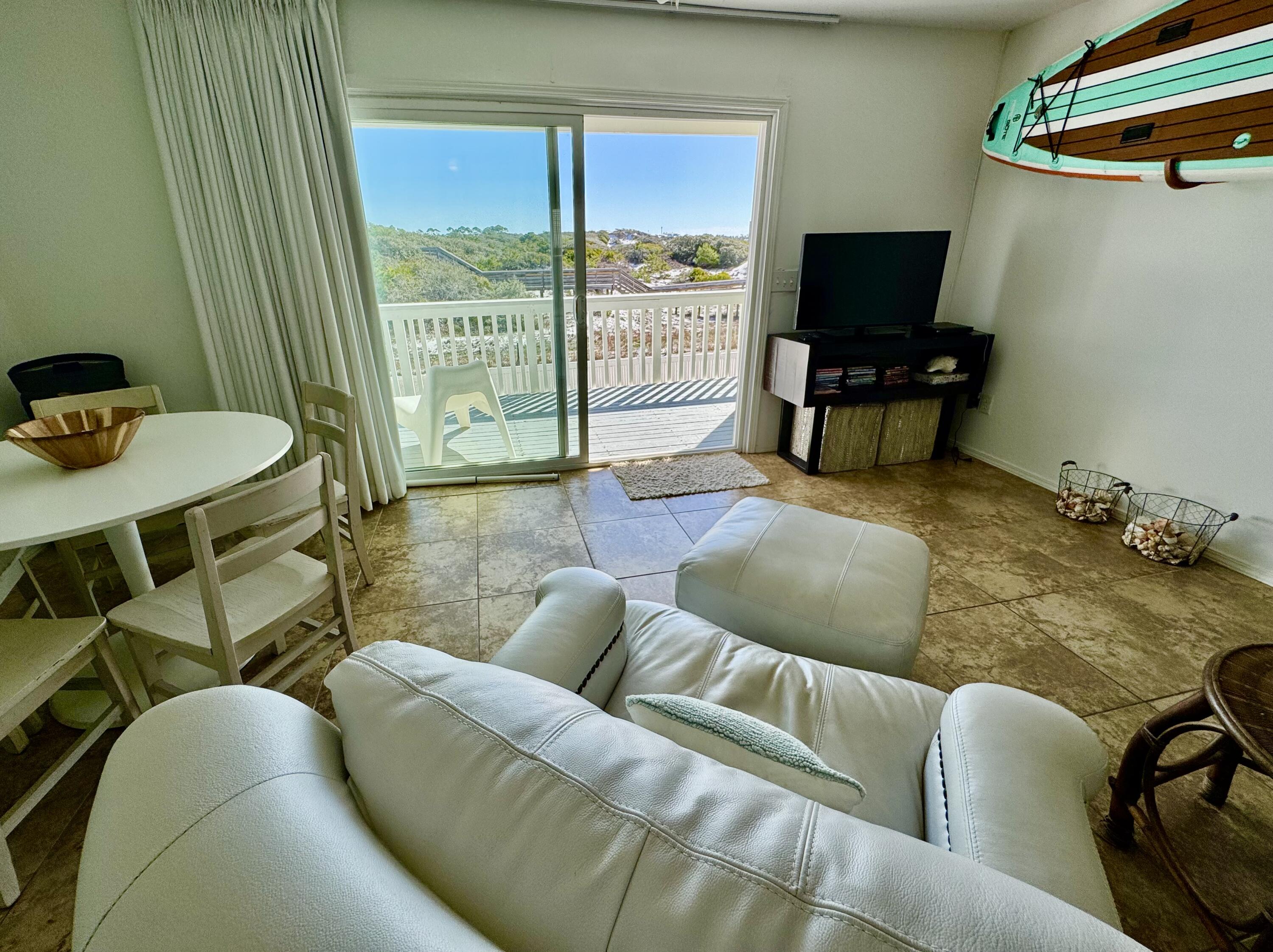 228 Walton Magnolia Lane, Unit 9 Inlet Beach, FL 32461 - Photo 4 of 24 a living room with furniture and a flat screen tv