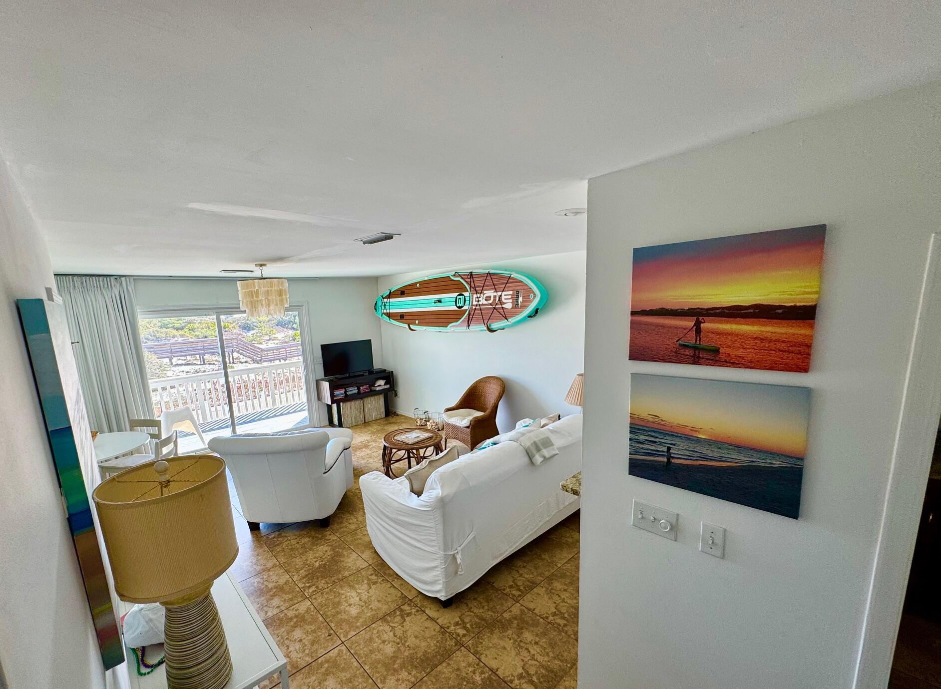 228 Walton Magnolia Lane, Unit 9 Inlet Beach, FL 32461 - Photo 5 of 24 a living room with furniture and a flat screen tv