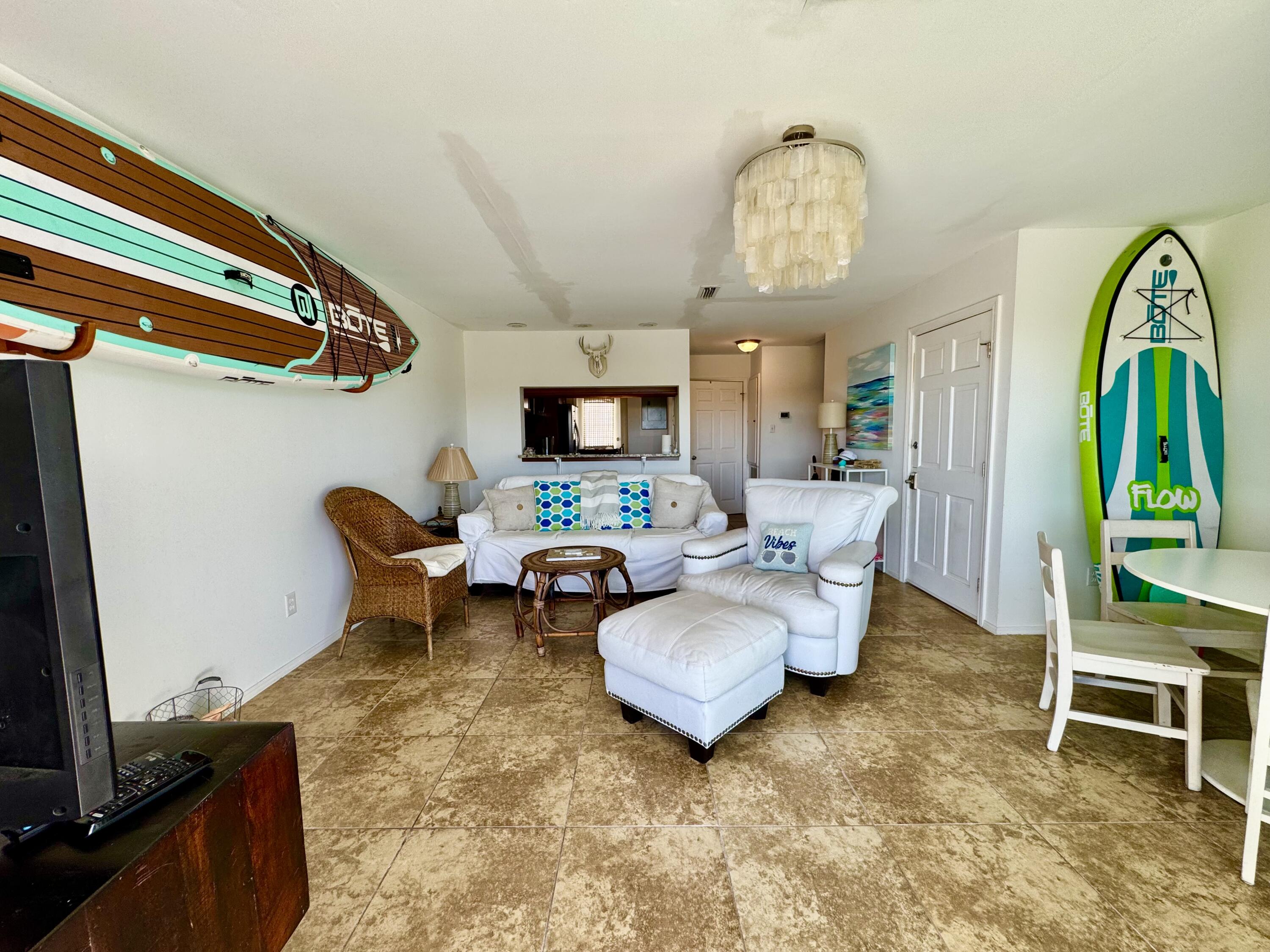 228 Walton Magnolia Lane, Unit 9 Inlet Beach, FL 32461 - Photo 6 of 24 a living room with furniture a fireplace and a flat screen tv