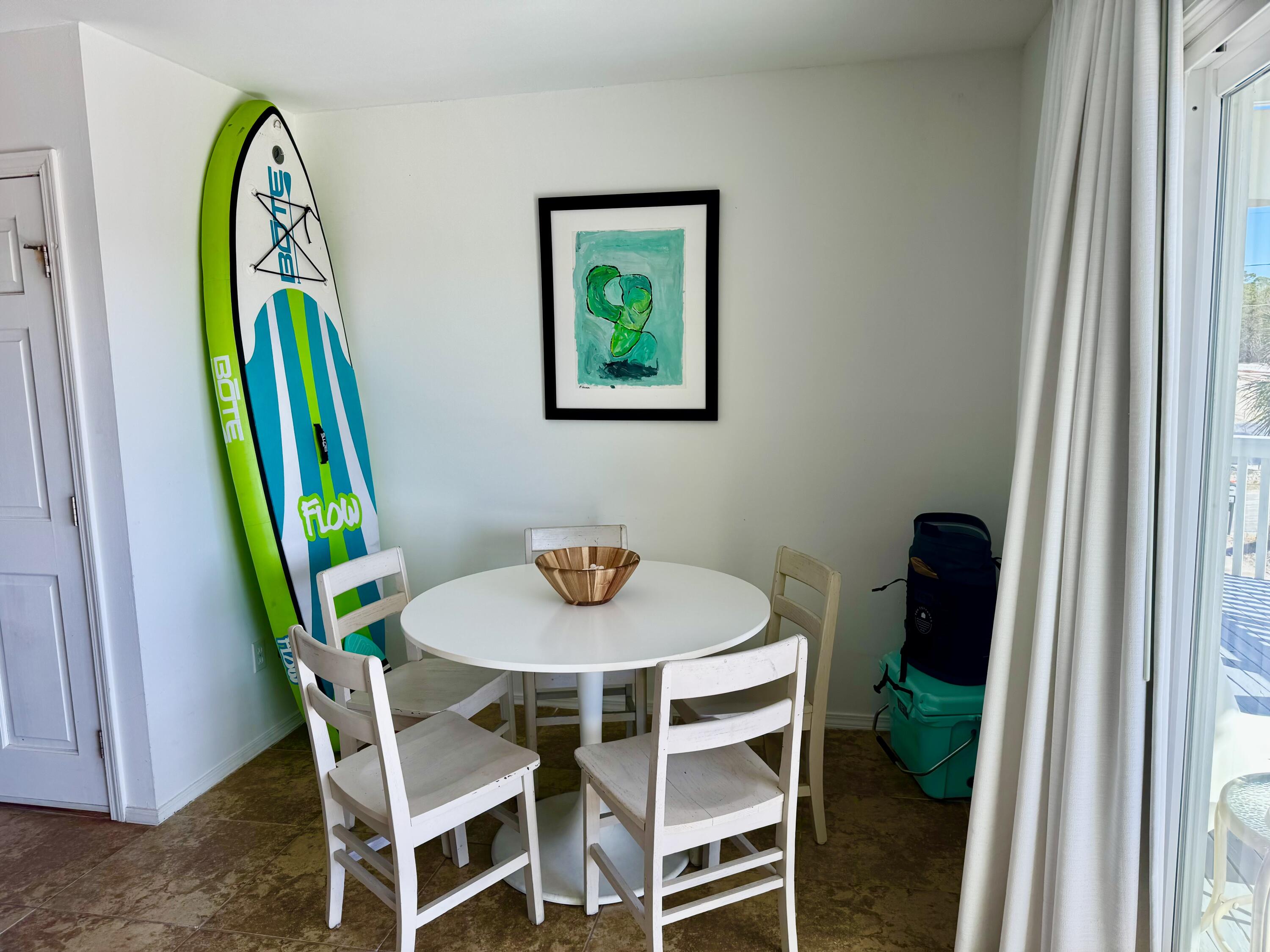 228 Walton Magnolia Lane, Unit 9 Inlet Beach, FL 32461 - Photo 8 of 24 a view of a dining room with furniture and a window