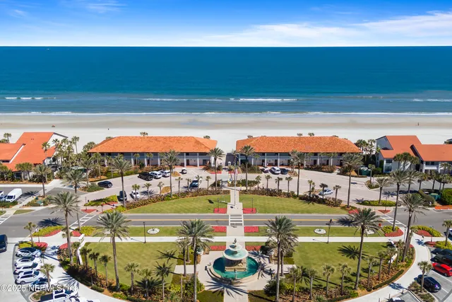 an aerial view of a houses with ocean view