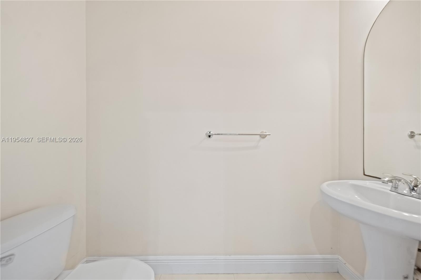 2951 Virginia Street, Unit 2953 Miami, FL 33133 - Photo 15 of 18 a bathroom with a sink and toilet