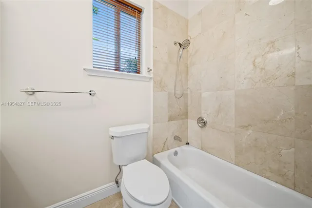 an empty room with a ceiling fan and a window