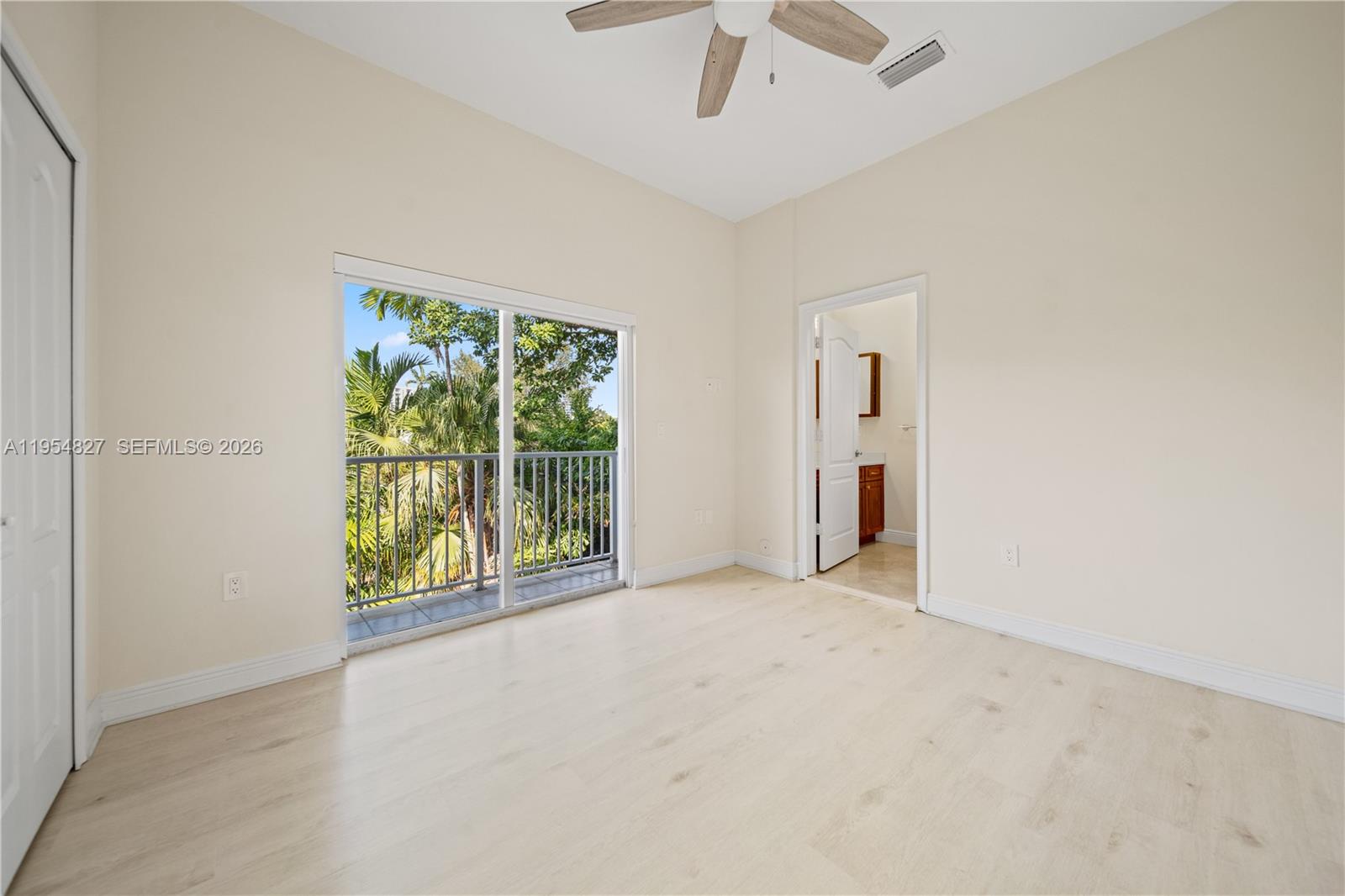 2951 Virginia Street, Unit 2953 Miami, FL 33133 - Photo 10 of 18 an empty room with a ceiling fan and a window