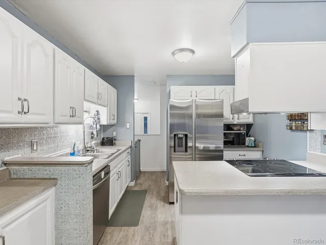a kitchen with a stove and white cabinets