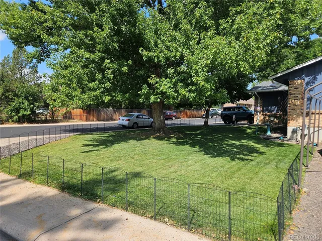 a view of a wooden house with a small yard