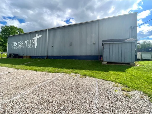 a front view of a building with outdoor seating