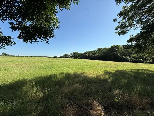 a view of a lake with a yard