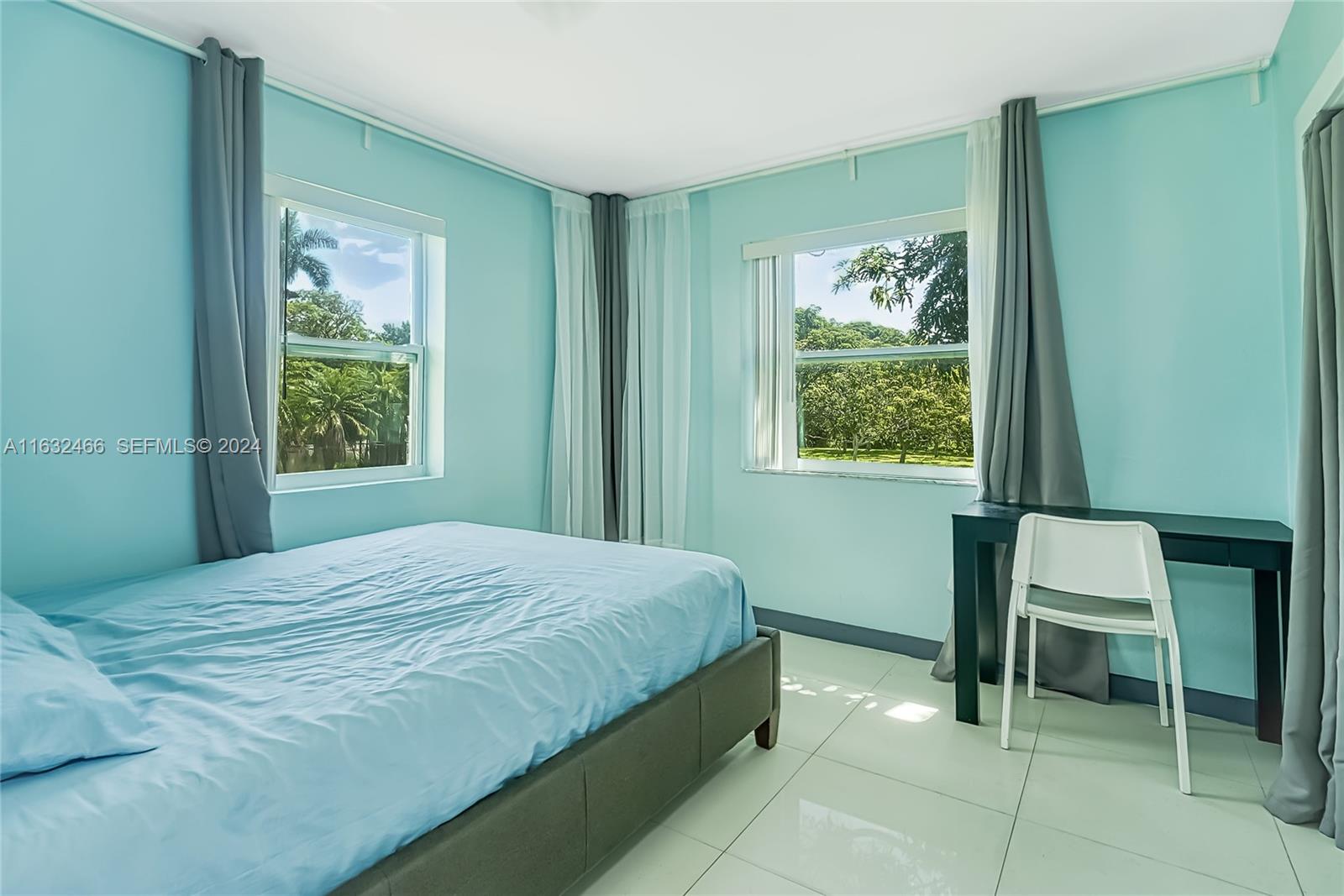 216 Southwest 6th Street Hallandale Beach, FL 33009 - Photo 12 of 70 a bedroom with a bed and a window