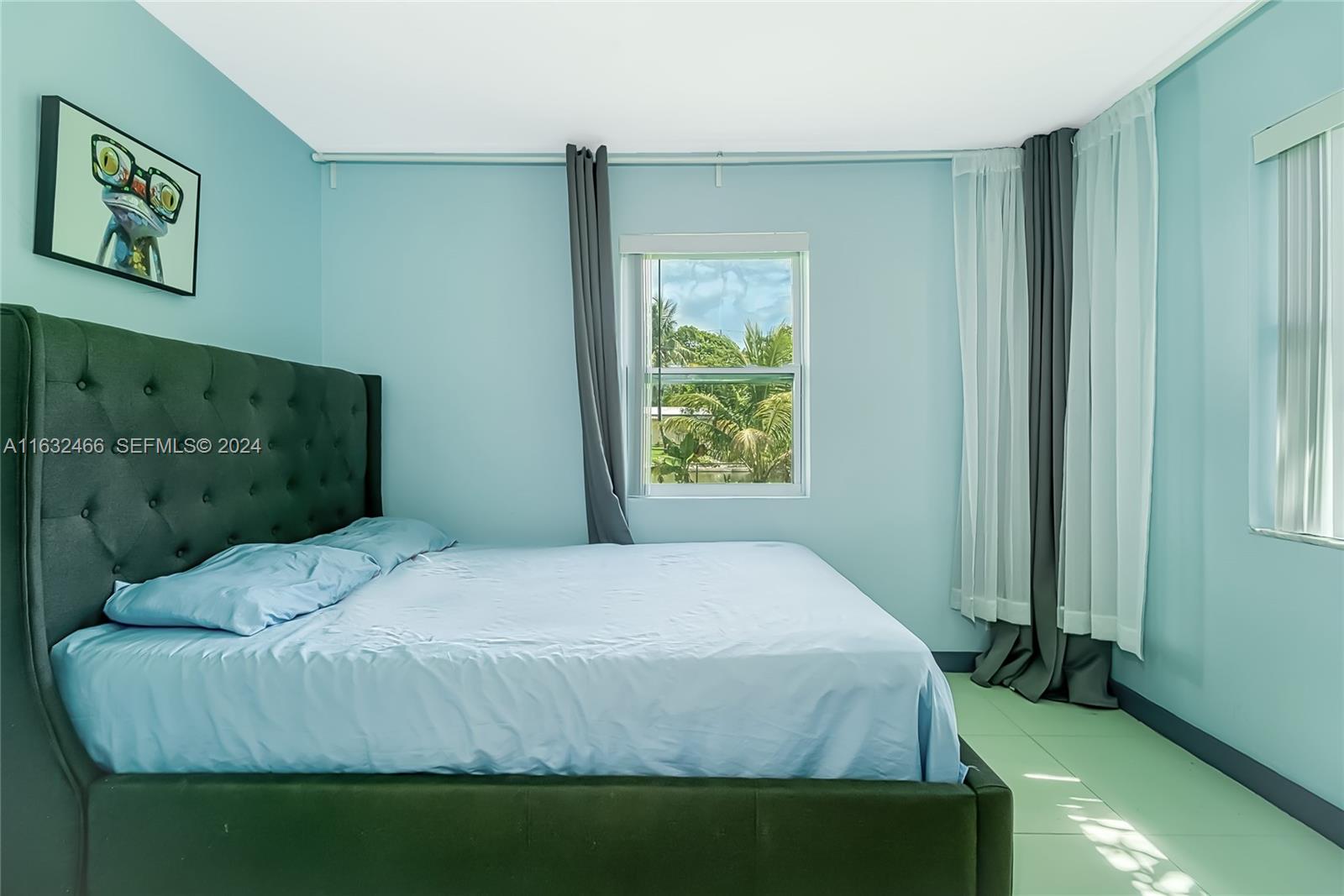 216 Southwest 6th Street Hallandale Beach, FL 33009 - Photo 13 of 70 a bedroom with a bed and a window