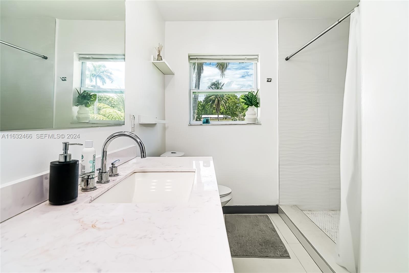 216 Southwest 6th Street Hallandale Beach, FL 33009 - Photo 20 of 70 a close view of a faucet a sink a window and a mirror