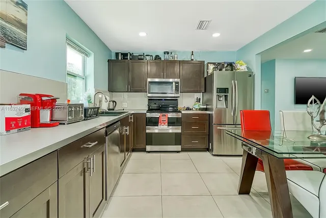 a kitchen with stainless steel appliances a stove sink and cabinets