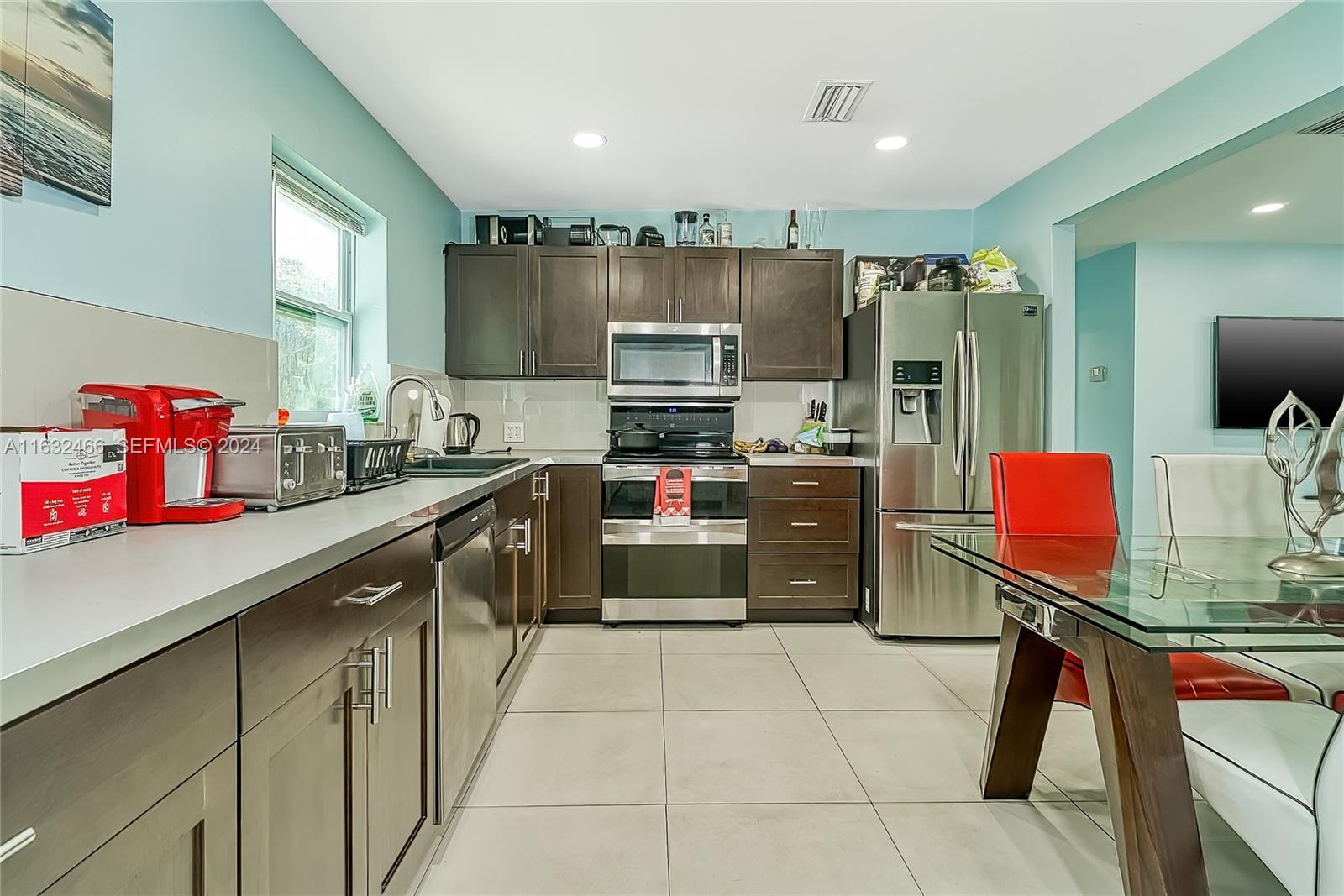 216 Southwest 6th Street Hallandale Beach, FL 33009 - Photo 2 of 70 a kitchen with stainless steel appliances a stove sink and cabinets