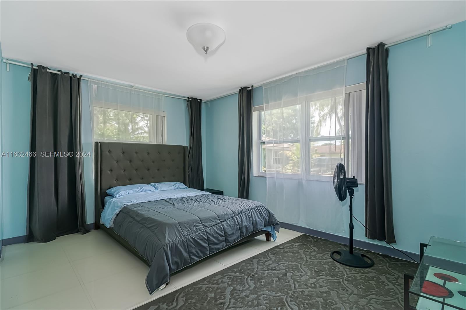 216 Southwest 6th Street Hallandale Beach, FL 33009 - Photo 22 of 70 a bedroom with a bed and a window