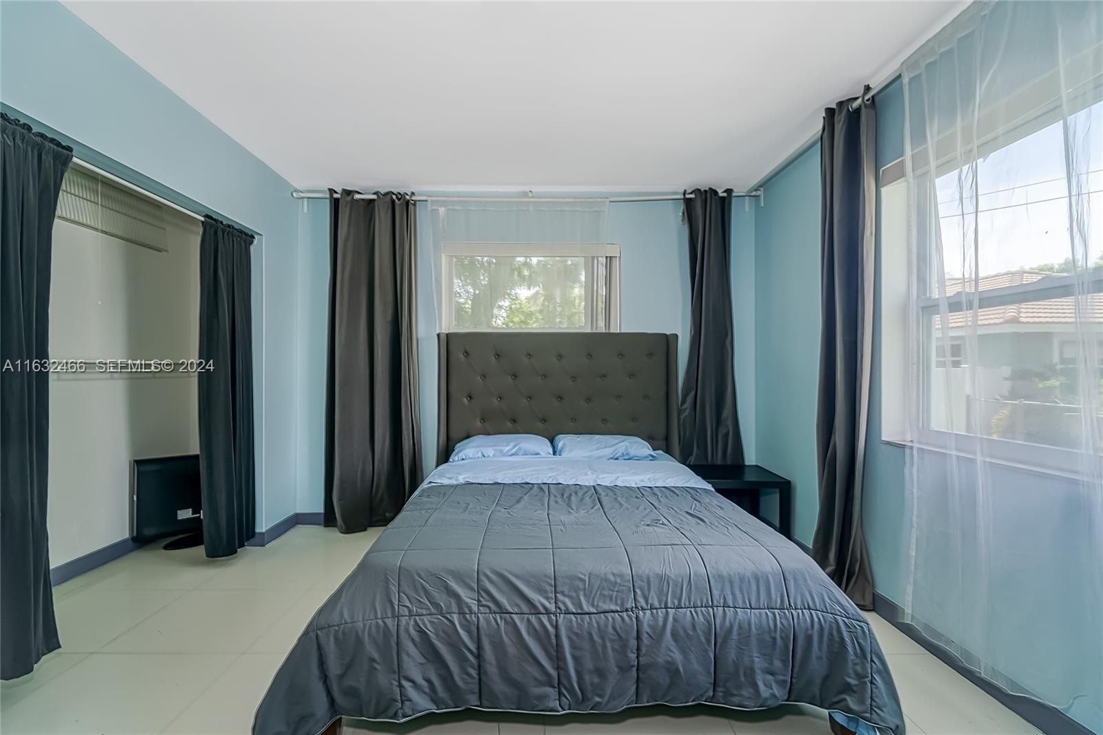 216 Southwest 6th Street Hallandale Beach, FL 33009 - Photo 23 of 70 a bedroom with a bed and a window