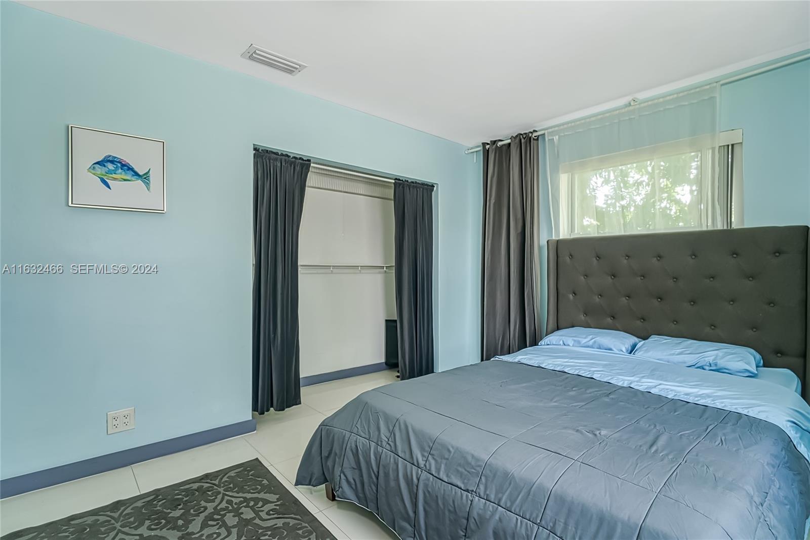 216 Southwest 6th Street Hallandale Beach, FL 33009 - Photo 24 of 70 a bedroom with a bed and a window