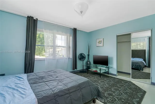 a bedroom with a bed and a chair