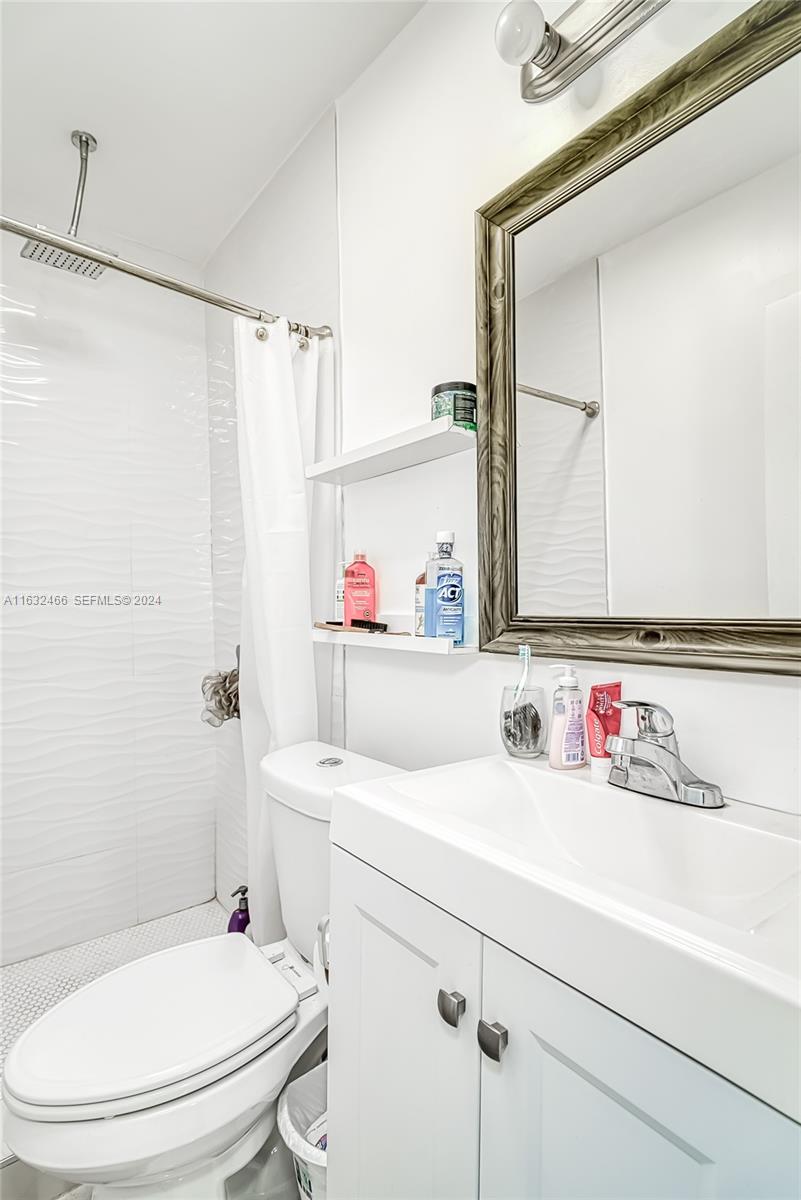 216 Southwest 6th Street Hallandale Beach, FL 33009 - Photo 27 of 70 a bathroom with a sink toilet vanity and shower