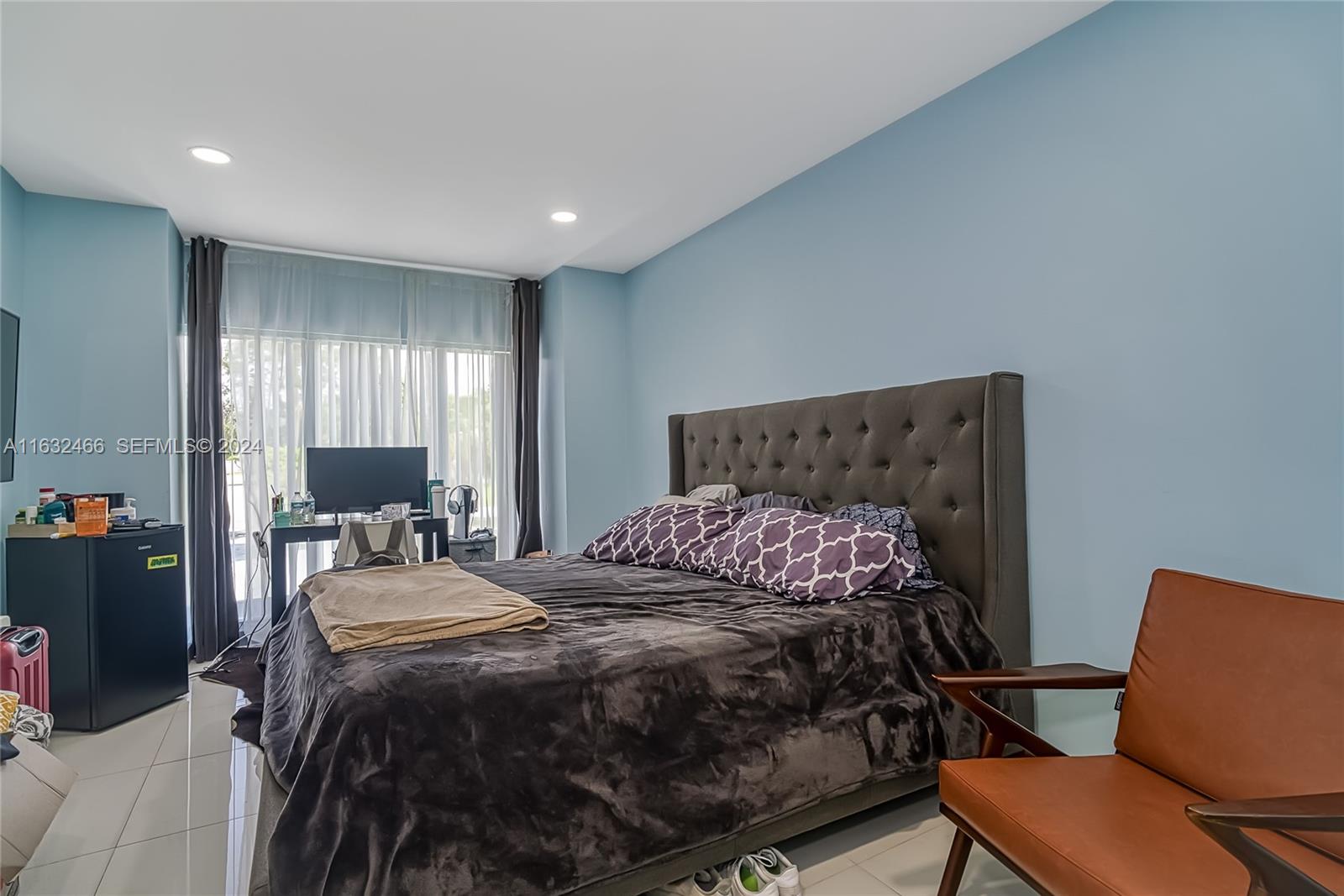 216 Southwest 6th Street Hallandale Beach, FL 33009 - Photo 32 of 70 a bedroom with a bed and a chair