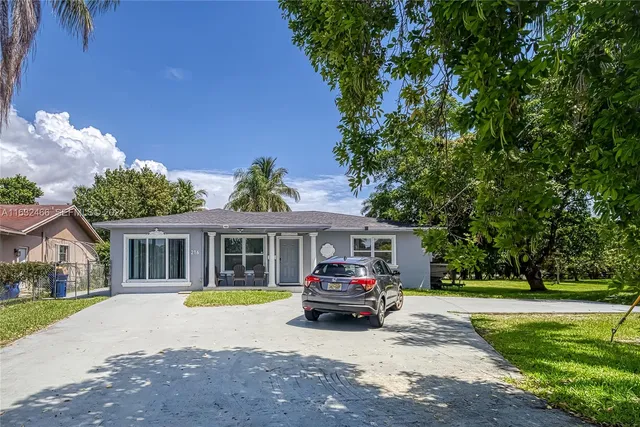 a view of a house with a garden and swimming pool