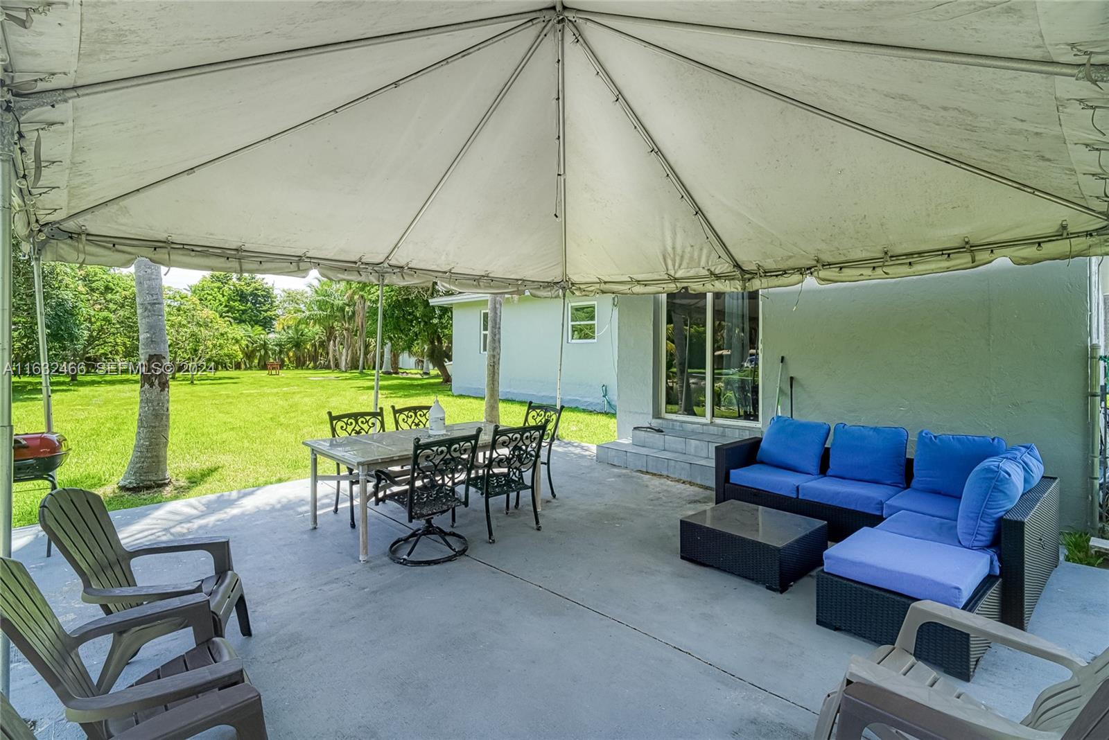216 Southwest 6th Street Hallandale Beach, FL 33009 - Photo 39 of 70 a view of a patio with couches chairs potted plants and a table