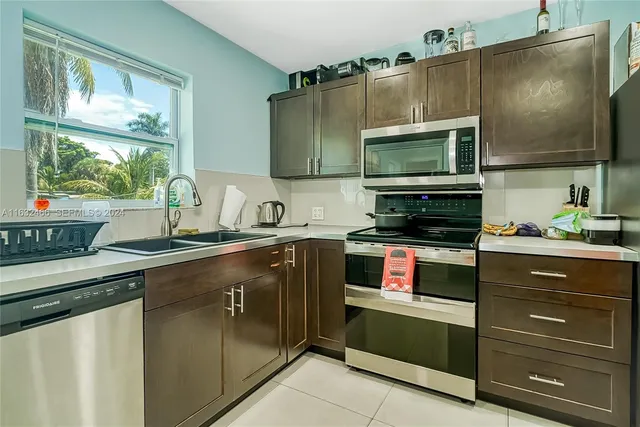 a kitchen with stainless steel appliances granite countertop a refrigerator and a microwave