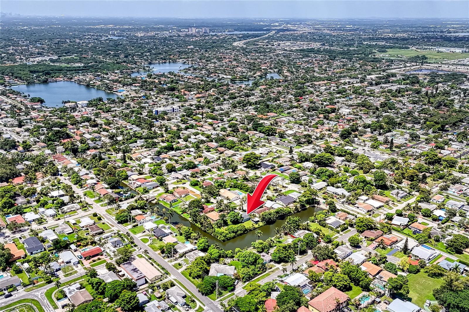216 Southwest 6th Street Hallandale Beach, FL 33009 - Photo 59 of 70 an aerial view of a houses with a lush green hillside