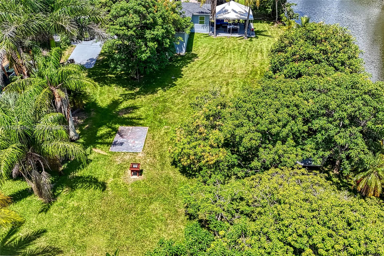 216 Southwest 6th Street Hallandale Beach, FL 33009 - Photo 67 of 70 a backyard of a house with lots of green space