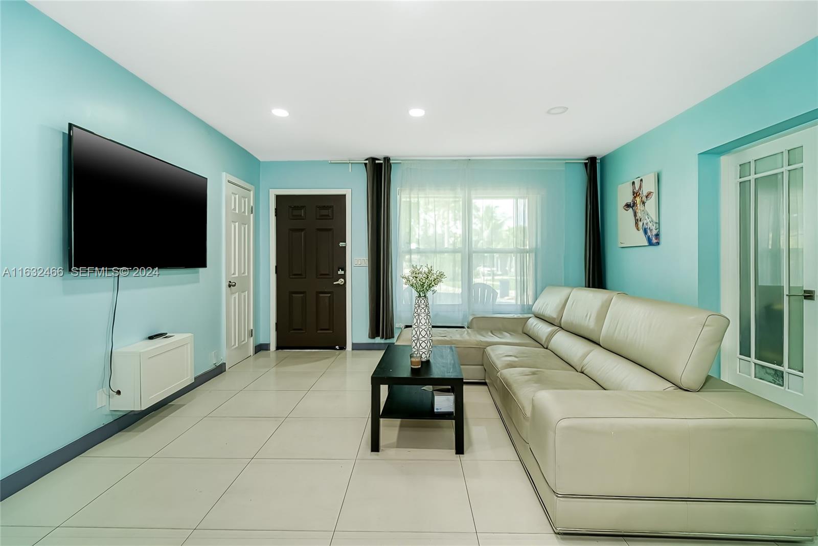 216 Southwest 6th Street Hallandale Beach, FL 33009 - Photo 9 of 70 a living room with furniture and a flat screen tv