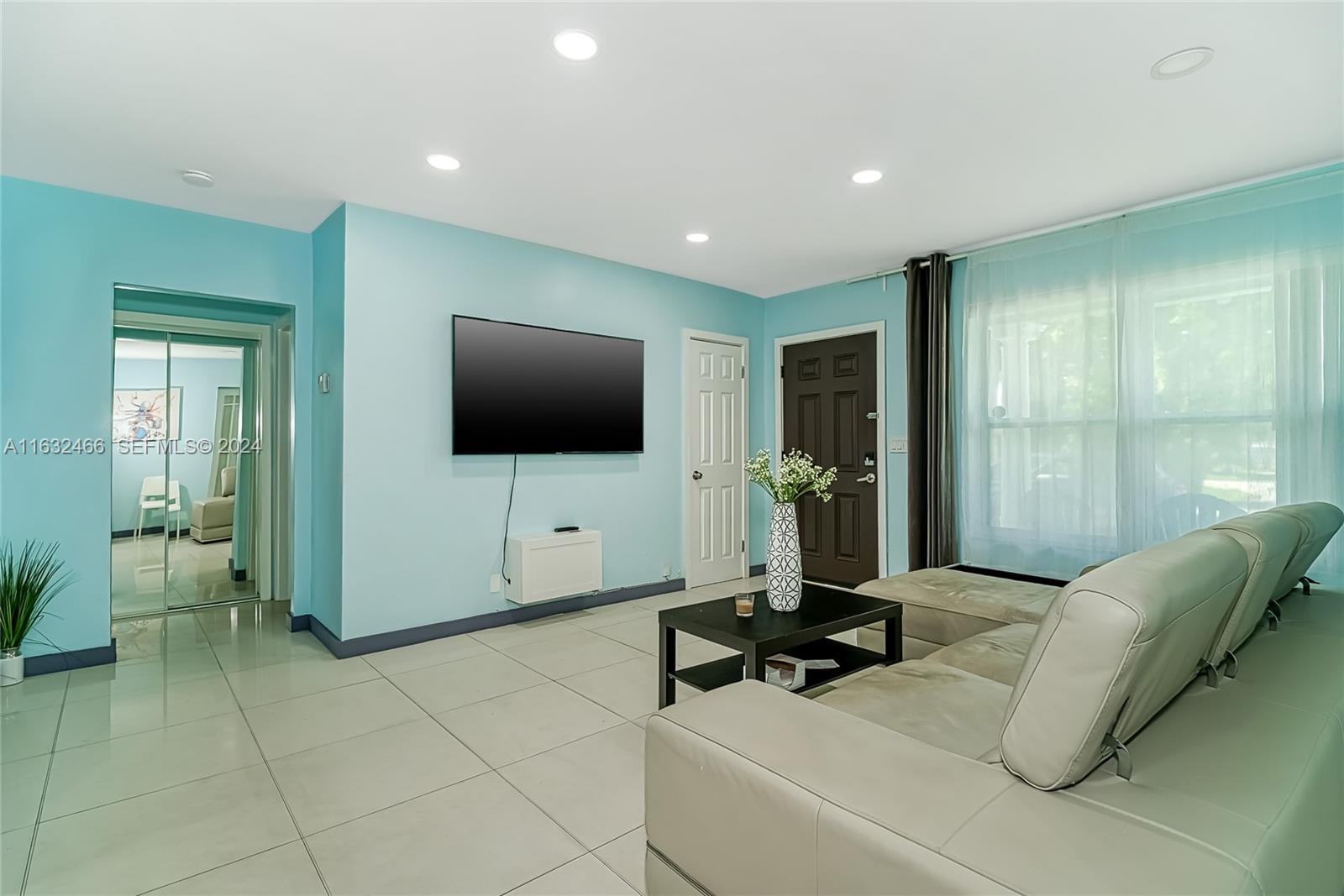 216 Southwest 6th Street Hallandale Beach, FL 33009 - Photo 10 of 70 a living room with furniture and a flat screen tv