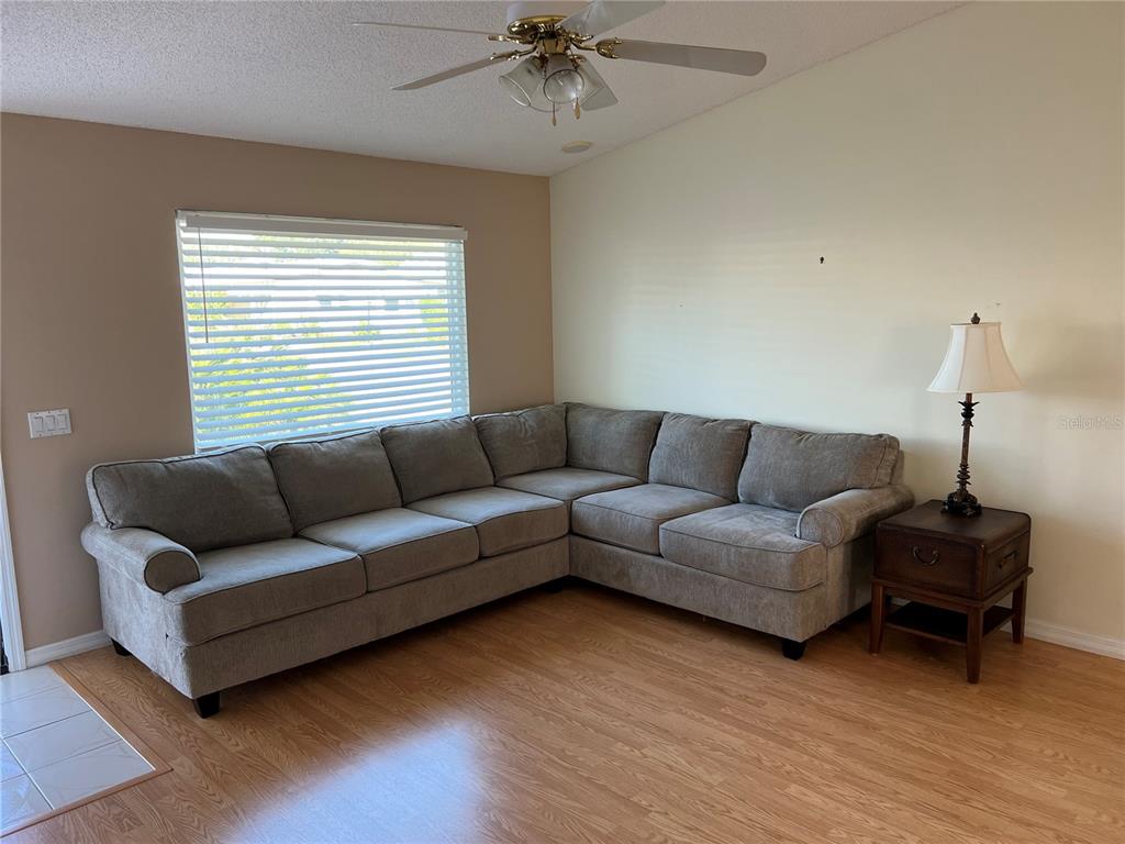 1232 Zapata Place Lady Lake, FL 32159 - Photo 2 of 10 a living room with furniture and a wooden floor