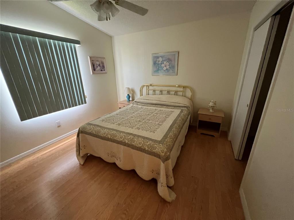 1232 Zapata Place Lady Lake, FL 32159 - Photo 9 of 10 a bedroom with a bed and a chandelier