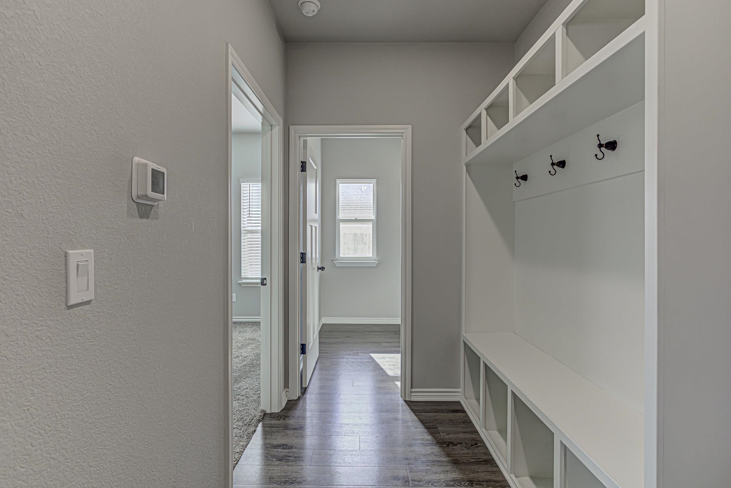 141 Rylee Road Burnet, TX 78611 - Photo 17 of 26 a view of a hallway with wooden floor