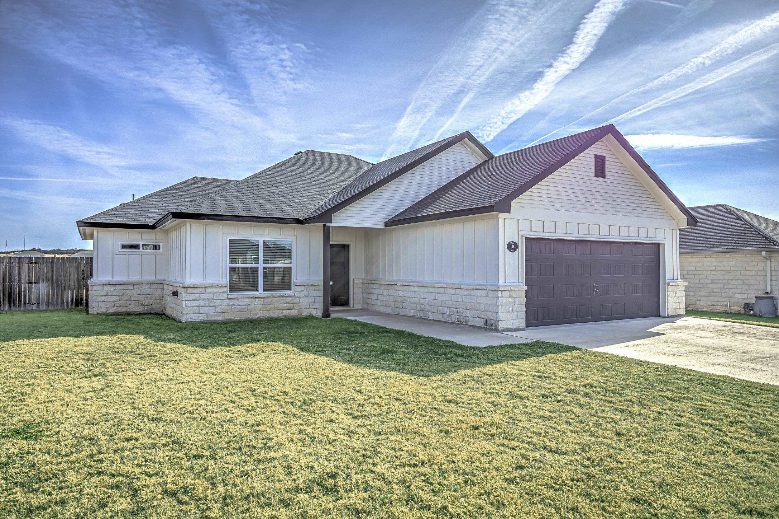 141 Rylee Road Burnet, TX 78611 - Photo 2 of 26 a view of a yard in front of a house with garage