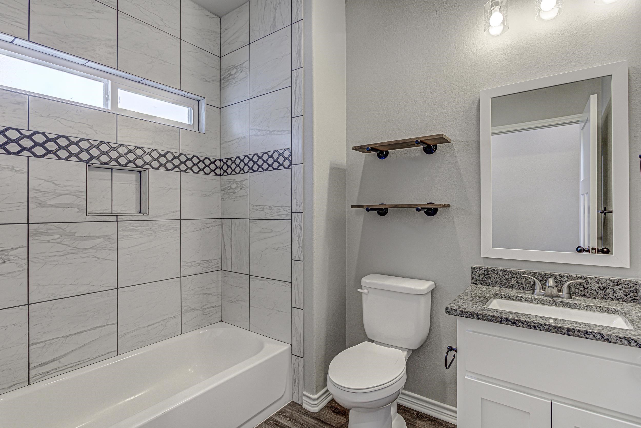 141 Rylee Road Burnet, TX 78611 - Photo 23 of 26 a bathroom with a toilet sink and shower