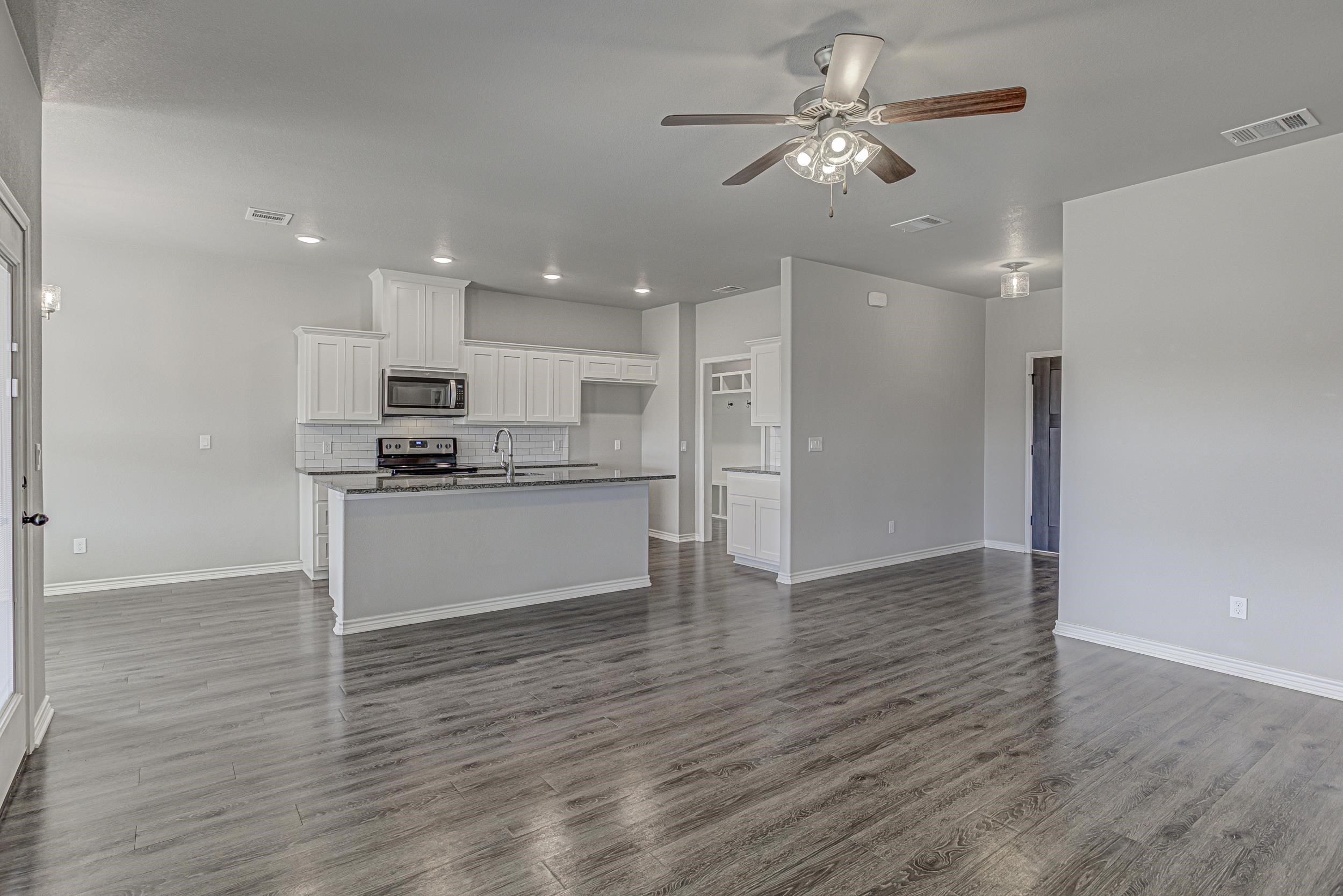 141 Rylee Road Burnet, TX 78611 - Photo 8 of 26 a view of kitchen with refrigerator microwave and stove