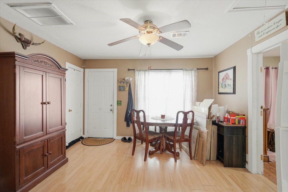 765 Norcross Road Wallis, TX 77485 - Photo 13 of 42 Bright dining area with natural light, featuring a ceiling fan, Neutral walls and light wood flooring create a cozy atmosphere.