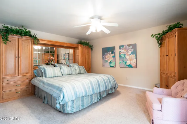 a bedroom with a bed mirror and window