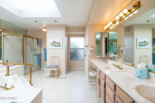 a bathroom with a tub sink and mirror