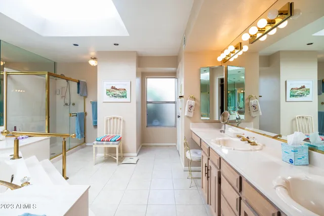 a bathroom with a tub sink and mirror