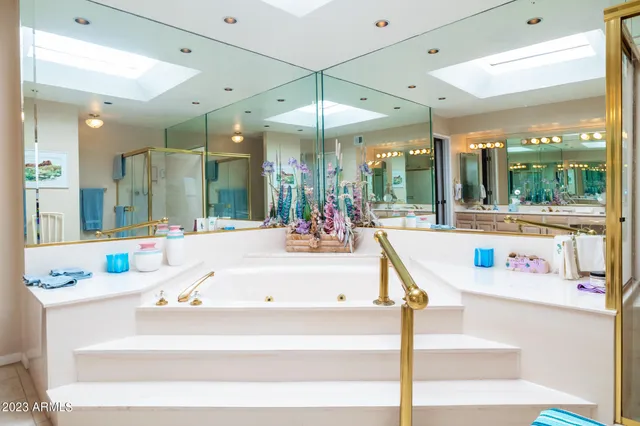 a living room with a large window and chandelier