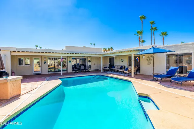 a view of a house with swimming pool having patio