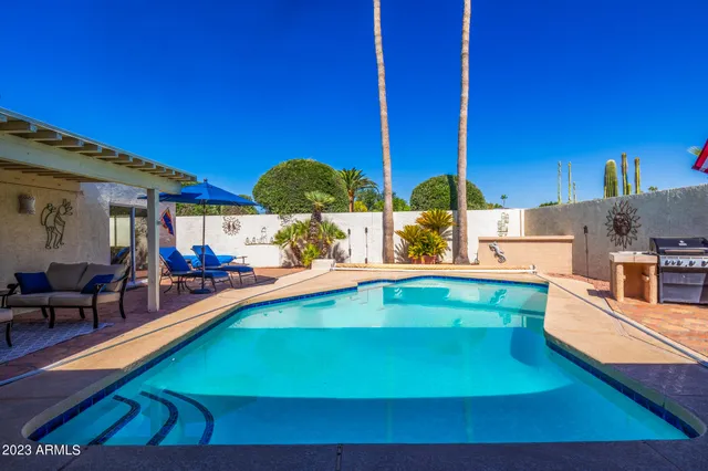 a view of a kitchen with swimming pool and chairs