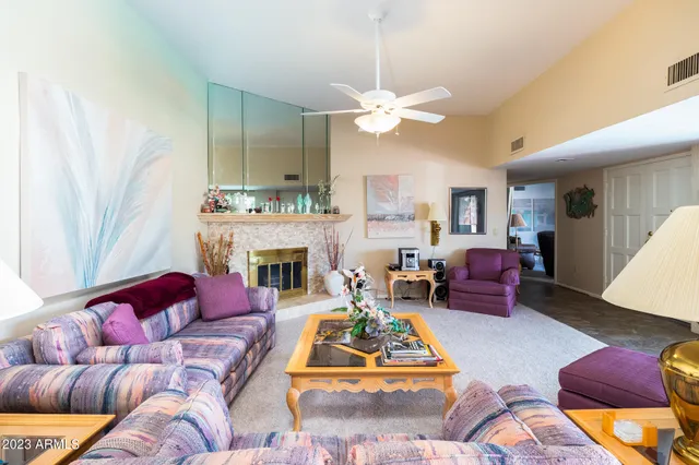 a living room with furniture fireplace and a window