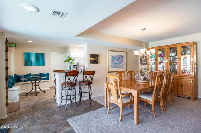a dining room with furniture and wooden floor