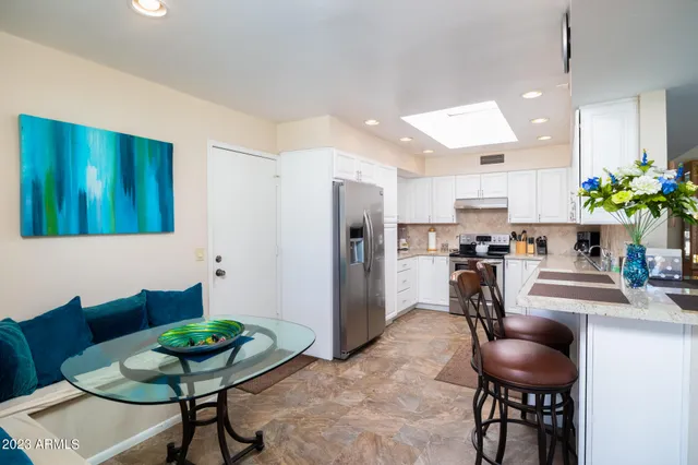 a dining room with furniture and a chandelier
