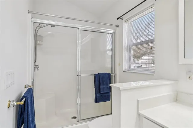 a bedroom with two beds and a chandelier