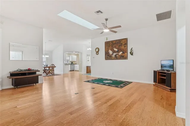 a kitchen with granite countertop a refrigerator a sink a stove top oven and cabinetry