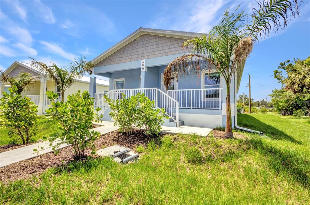 409 Carmalita Street, Unit 111 & 112 Punta Gorda, FL 33950 - Photo 1 of 75 a front view of a house with a yard